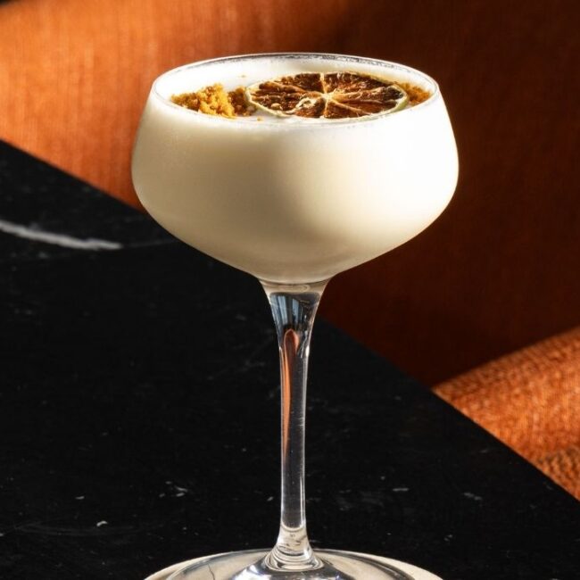 Cocktail with dried citrus garnish promoting Daily Happy Hour at Aviator Bar in Mawson Lakes, Adelaide