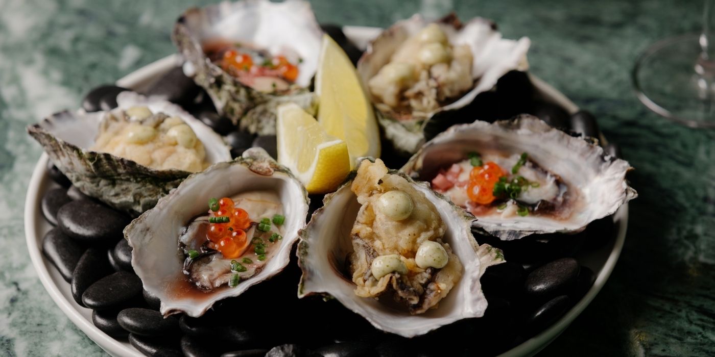 Oysters with assorted toppings and fresh lemon for the Friday and Saturday Oyster Special at Aviator Bar in Mawson Lakes, Adelaide